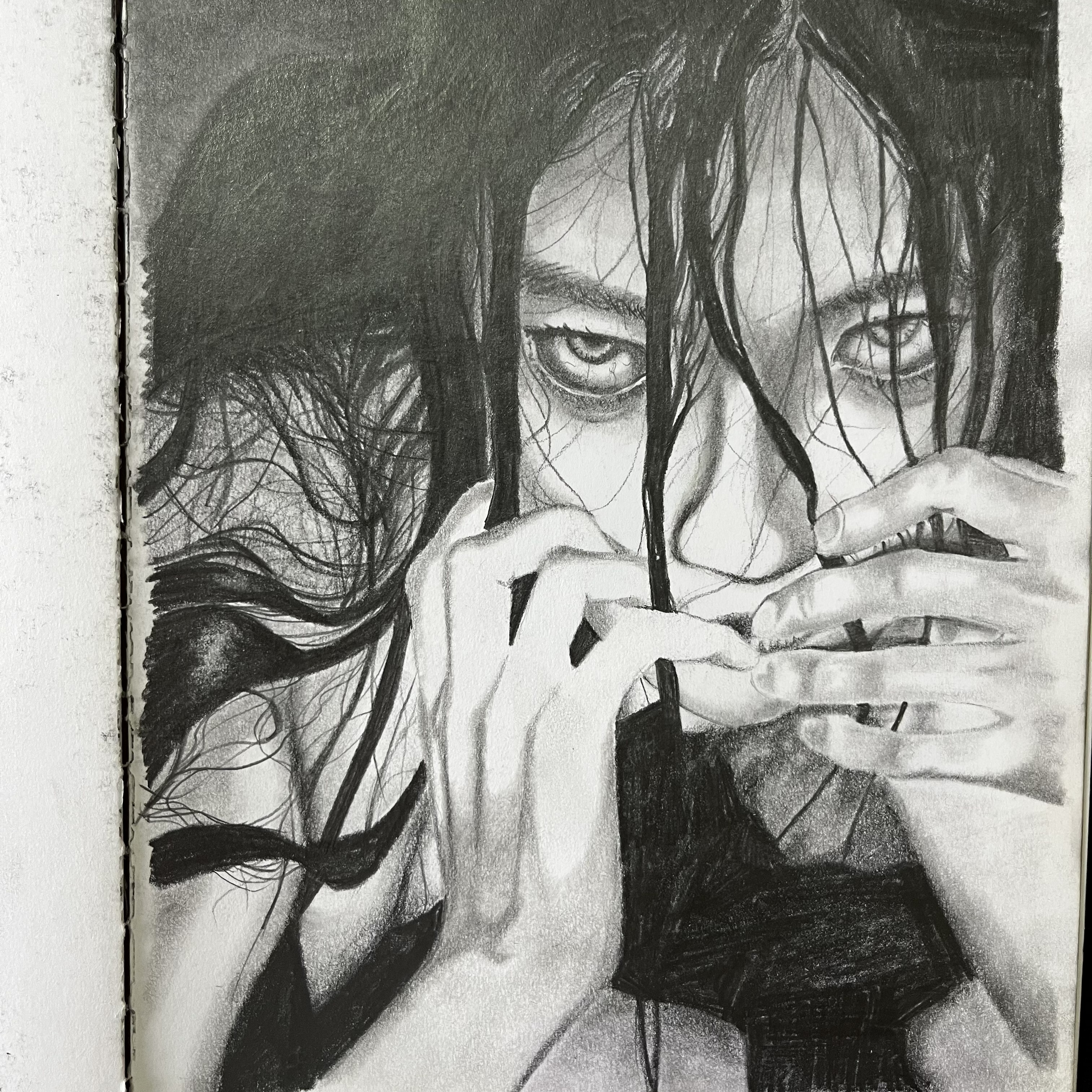 Graphite drawing of an intense portrait with hands partially covering the face